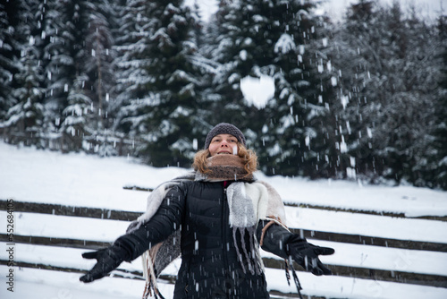 woman enjoying snow in winter