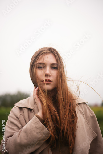 Young girl against the sky in the summer.