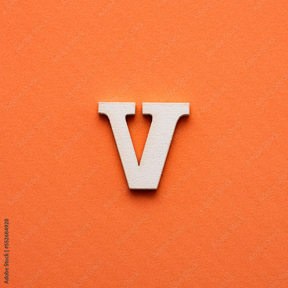 Letter V uppercase - white wooden font on pink background