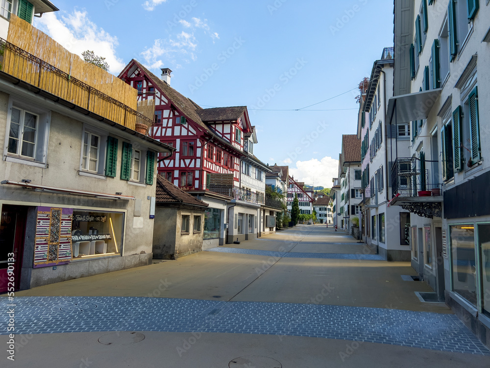 A historic alley with old half-timbered houses.
