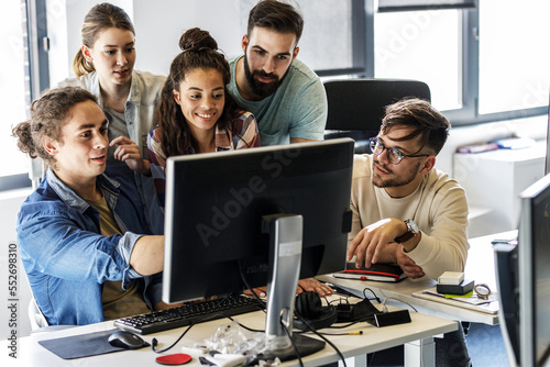 Group of programmers and game developers working on a new project at the office.	
