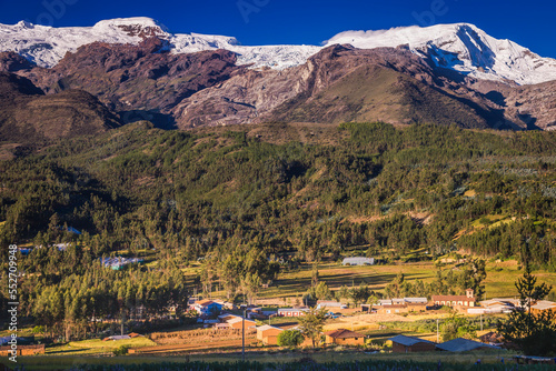 Village and Huascaran in Cordillera Blanca at sunrise, snowcapped Andes
