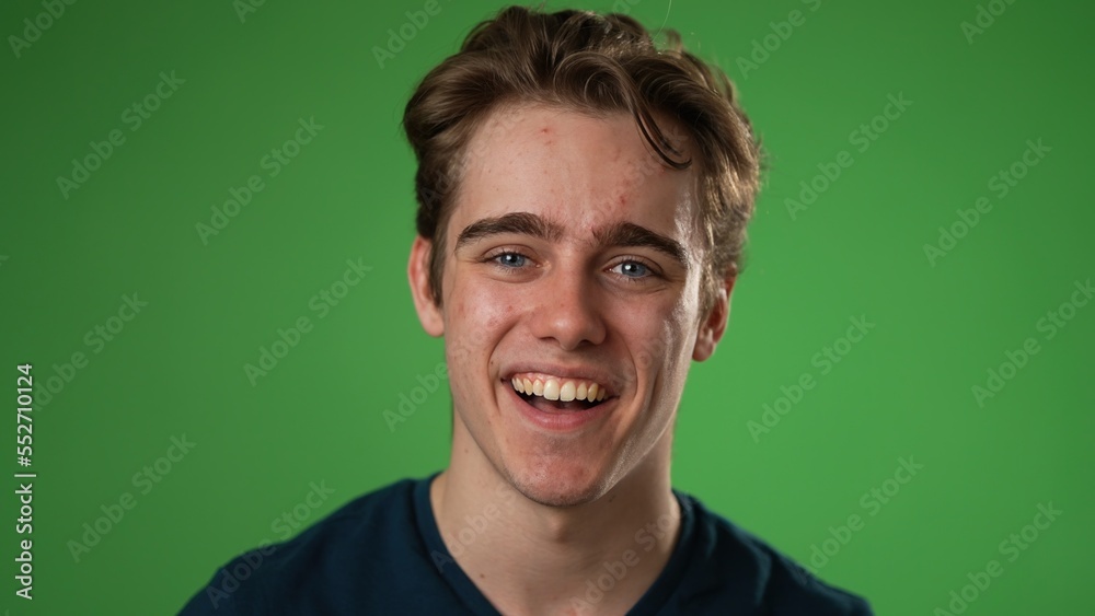Closeup portrait of smiling happy young hipster man 20s isolated on green screen chroma key background in studio Closeup portrait of smiling happy young hipster man 20s isolated on green screen chroma key background in studio