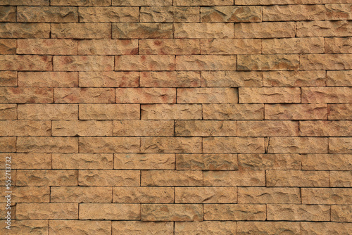 Beautiful stone wall made of bricks as background, closeup