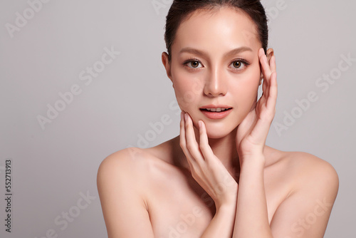 Beautiful young asian woman with clean fresh skin on grey background, Face care, Facial treatment, Cosmetology, beauty and spa, Asian women portrait.