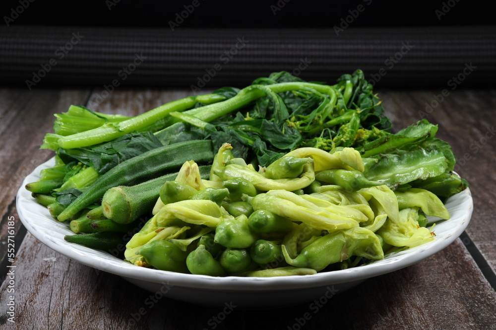 Pile of boiled mixed vegetable serving on the plate. Famous side dish menu in Asia restaurant. Pile of boiled mixed vegetable serving on the plate. Famous side dish menu in Asia restaurant.
