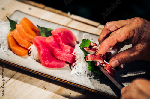 Sashimi Japanese food, Sashimi set. Salmon, wasabi, fish, shrimp,octopus, sashimi, hirame, salmon sashimi and tuna sashimi, Japanese food concept, with copy space. Dark Tone