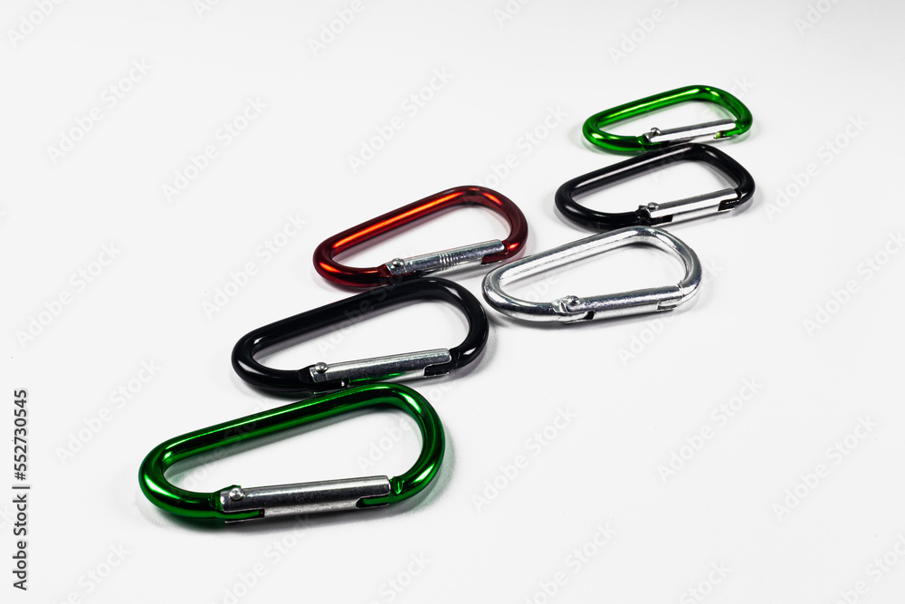 Six small colored carabiners on a white background Six small colored carabiners on a white background