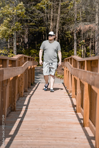 person walking on a wooden bridge