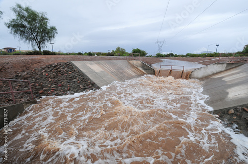 Stormwater runoff flowing in an open channel system after heavy rain in Mesa, Arizona, in 2018 photo