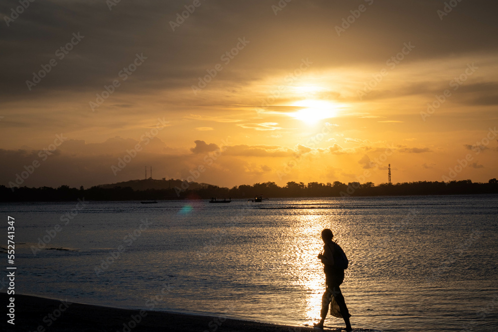 Fototapeta premium sunset walk on the beach in tropical indonesia