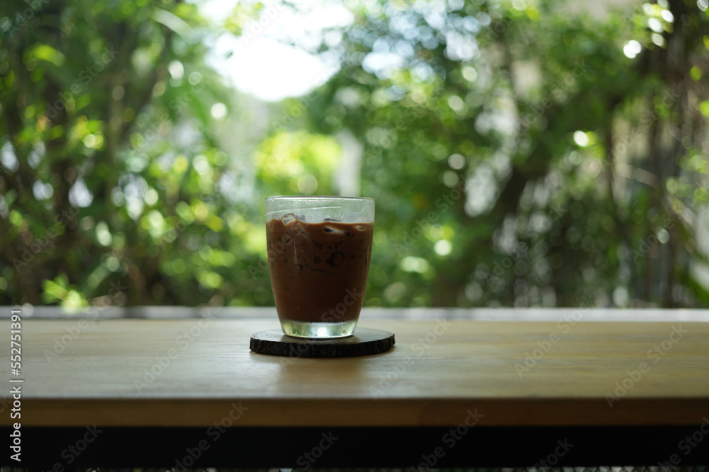 Ice Mocha coffee on wood table. Early morning sun light with copy space. Ice Mocha coffee on wood table. Early morning sun light with copy space.