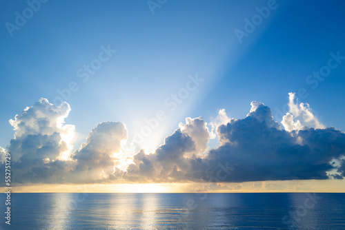 Sunset on sea background. Nature wallpaper with summer sea. Water sea texture. Calm sunrise on tropical sea. Clouds and waves on ocean dusk, twilight.