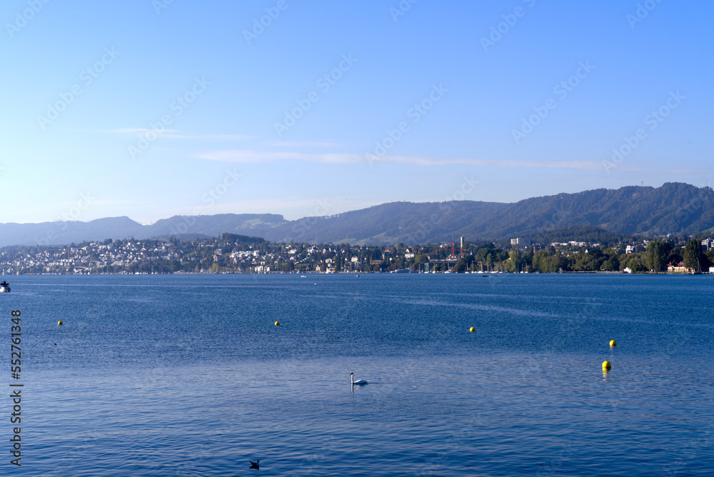 Scenic view over Lake Zürich seen from City of Zürich with pier and Swiss Alps in the background on a sunny late summer day. Photo taken September 22, 2022, Zurich, Switzerland.