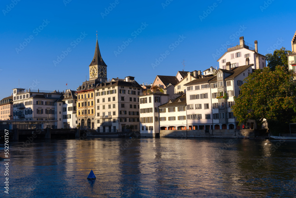 Beautiful cityscape of the old town of Zürich with Limmat River in the foreground with historic houses and bridge on a sunny late summer morning. Photo taken September 22nd, 2022, Zurich, Switzerland.
