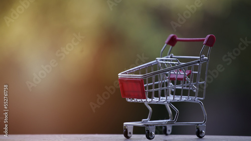 Close up a shopping Cart Isolated on green blakground sunset photo