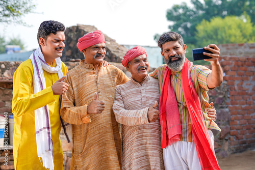 Indian villagers group taking selfie in smartphone