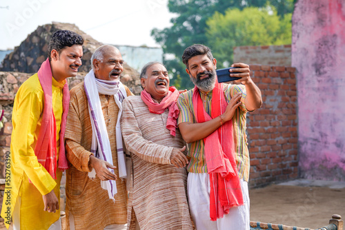Indian villagers group taking selfie in smartphone