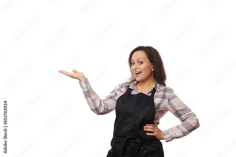 Cheerful smiling multiethnic brunette woman, female bartender, barmaid, waitress, in black apron, selling hot drink coffee, tea, holding a copy space for your advertising, isolated on white background Cheerful smiling multiethnic brunette woman, female bartender, barmaid, waitress, in black apron, selling hot drink coffee, tea, holding a copy space for your advertising, isolated on white background