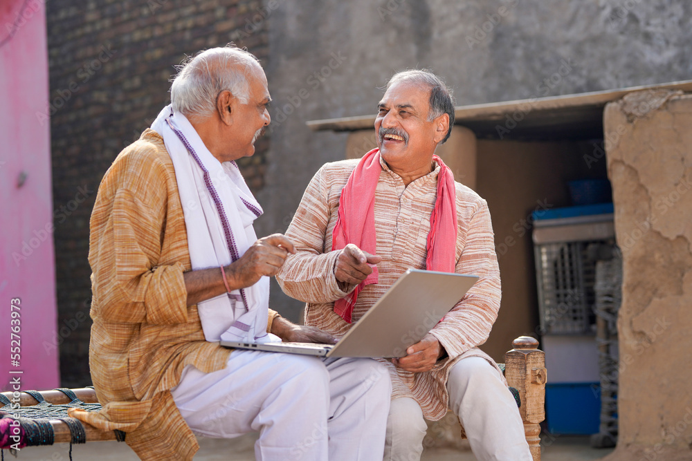 Two indian old man using laptop at out of home - obrazy, fototapety, plakaty 