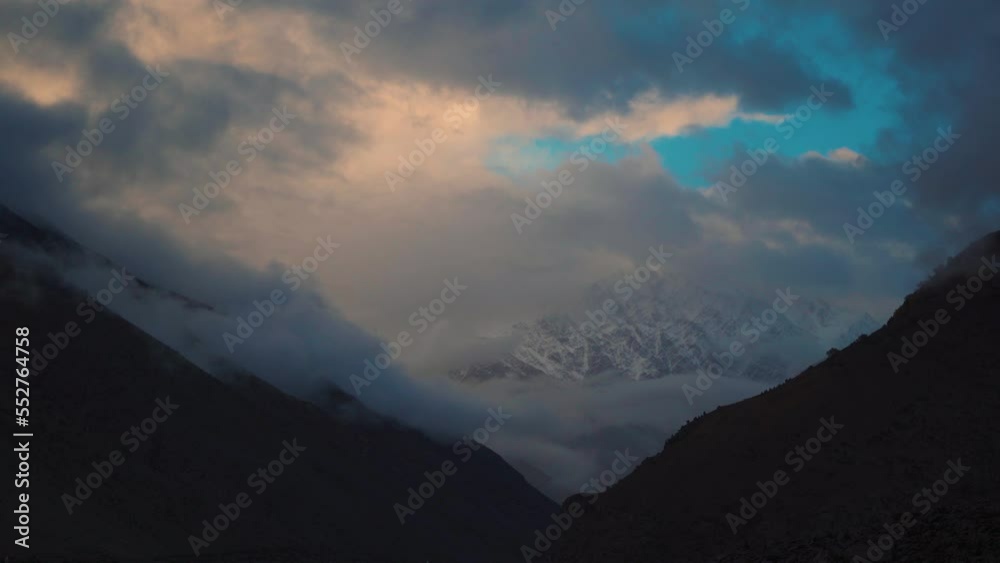 4K shot of clouds above the snowy mountain peaks during the sunset at Darcha in Lahaul Spiti district, Himachal Pradesh, India. Clouds cover the snowy mountain peaks during the snowstorm in mountains. 4K shot of clouds above the snowy mountain peaks during the sunset at Darcha in Lahaul Spiti district, Himachal Pradesh, India. Clouds cover the snowy mountain peaks during the snowstorm in mountains.