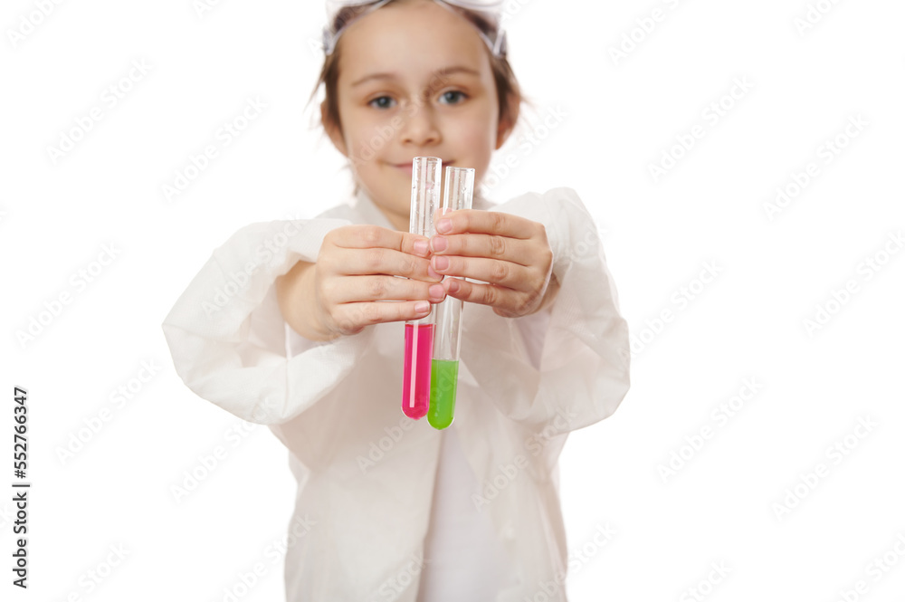 Selective focus on little child's hands holding out test tubes, showing the current chemical reaction with reagents in them to the camera. Miracles of chemistry science, isolated on white background Selective focus on little child's hands holding out test tubes, showing the current chemical reaction with reagents in them to the camera. Miracles of chemistry science, isolated on white background