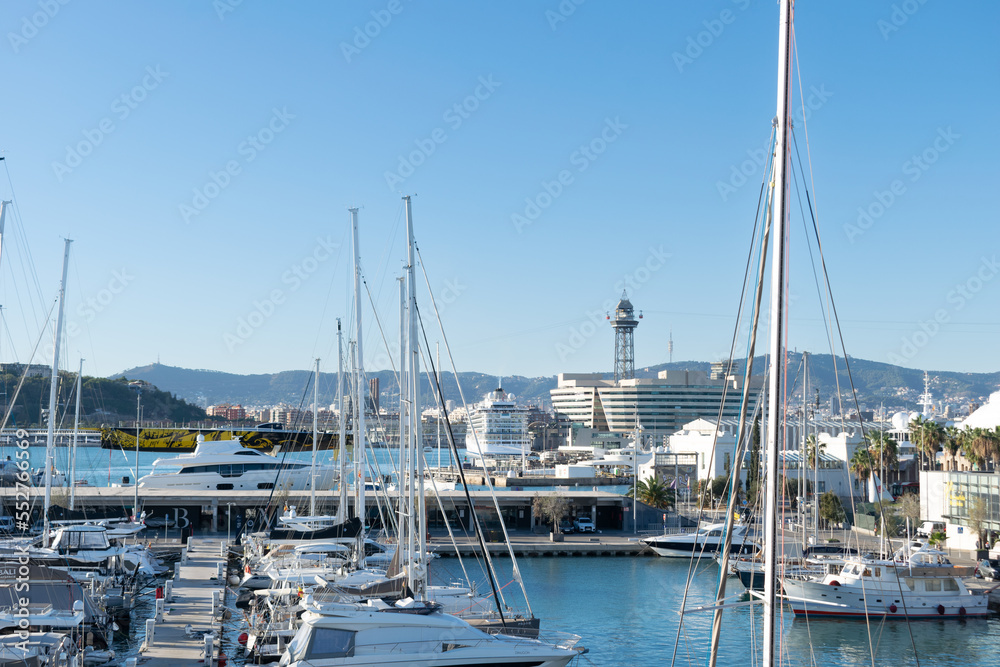 Fishing boats and yachts moored in the port on a sunny day
