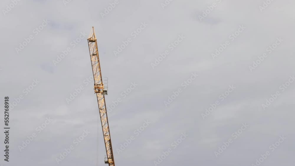 construction crane moves against the background of the sky,construction and architecture construction crane moves against the background of the sky,construction and architecture
