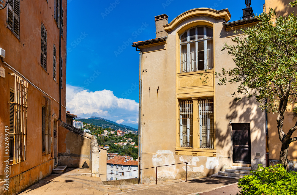 Historic medieval clock tower and tenement houses at Place du 24 Aout square in old town quarter of perfumery city of Grasse in France