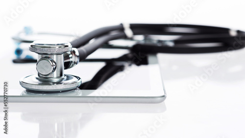 Stethoscope and digital tablet on white background