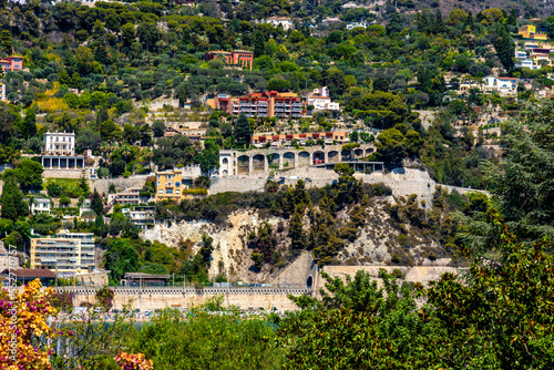 Residential area rising above harbor beach onshore Azure Cost of Mediterranean Sea in Villefranche-sur-Mer resort town in France photo