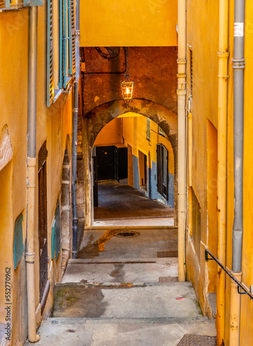 Entry to historic XIII century Rue Obscure Dark Covered Street underground passageway under harbor front houses in old town quarter of Villefranche-sur-Mer in France photo