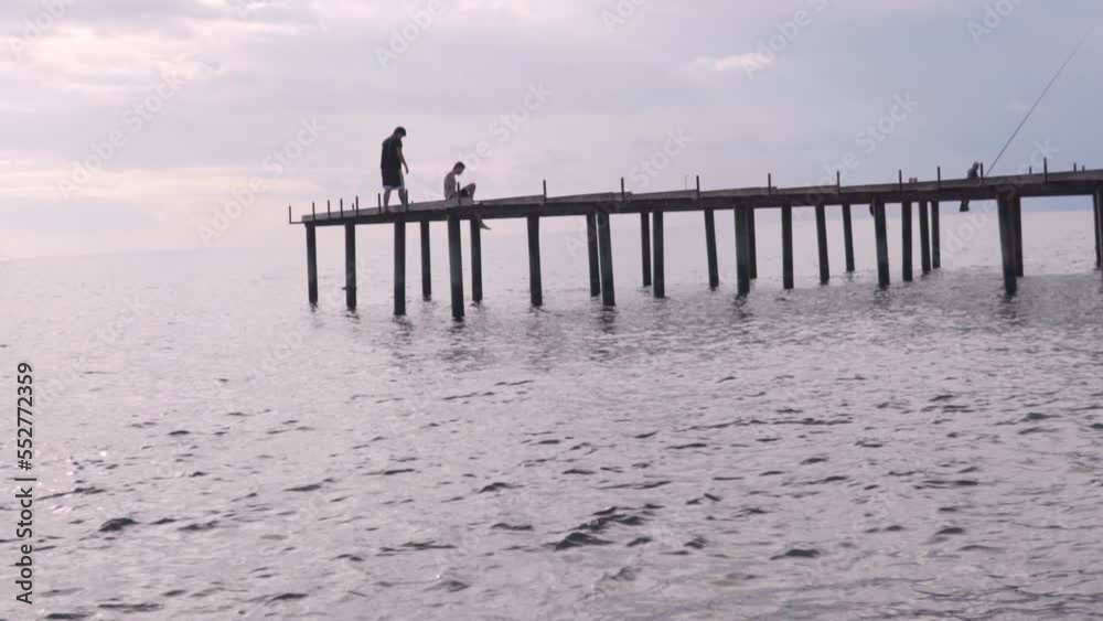 Fishermen fish on the pier by the sea. Turkey, Alanya Fishermen fish on the pier by the sea. Turkey, Alanya