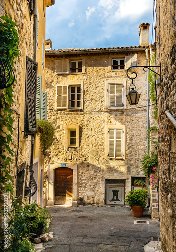 Narrow streets and colorful historic houses of old town quarter with Rue de la Place Vieille street in medieval riviera resort of Vence in France