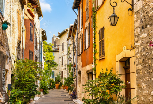 Fototapeta Naklejka Na Ścianę i Meble -  Narrow streets and colorful historic houses of old town quarter with Rue de la Coste street in medieval riviera resort of Vence in France