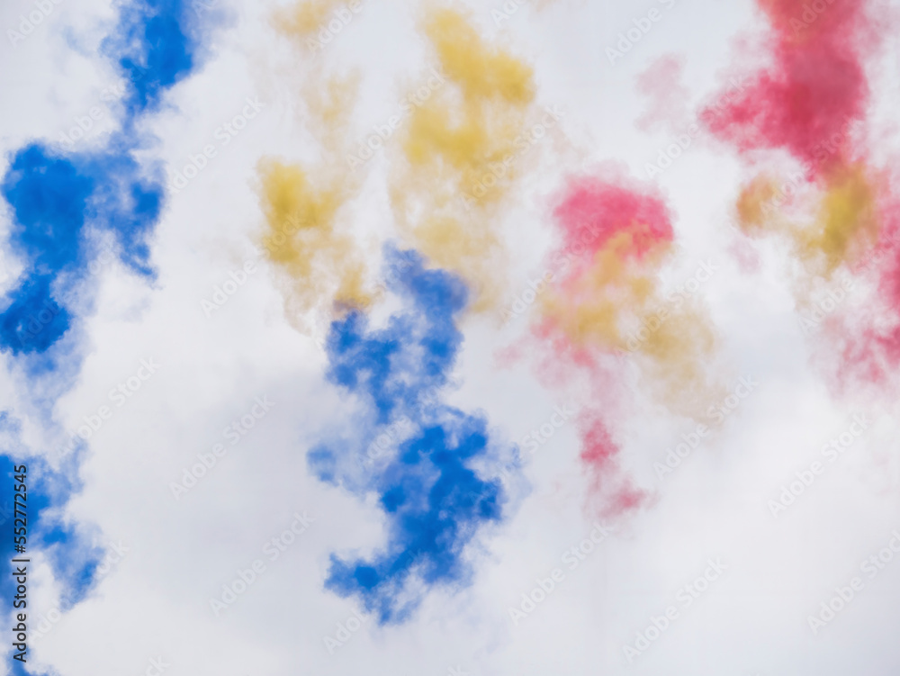 trails of smoke with the colors of the national flag of Romania in the air left by airplanes.