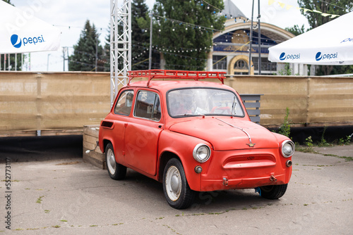 Little red car running in the city. 25 August 2022 - Ukraine, Kyiv photo