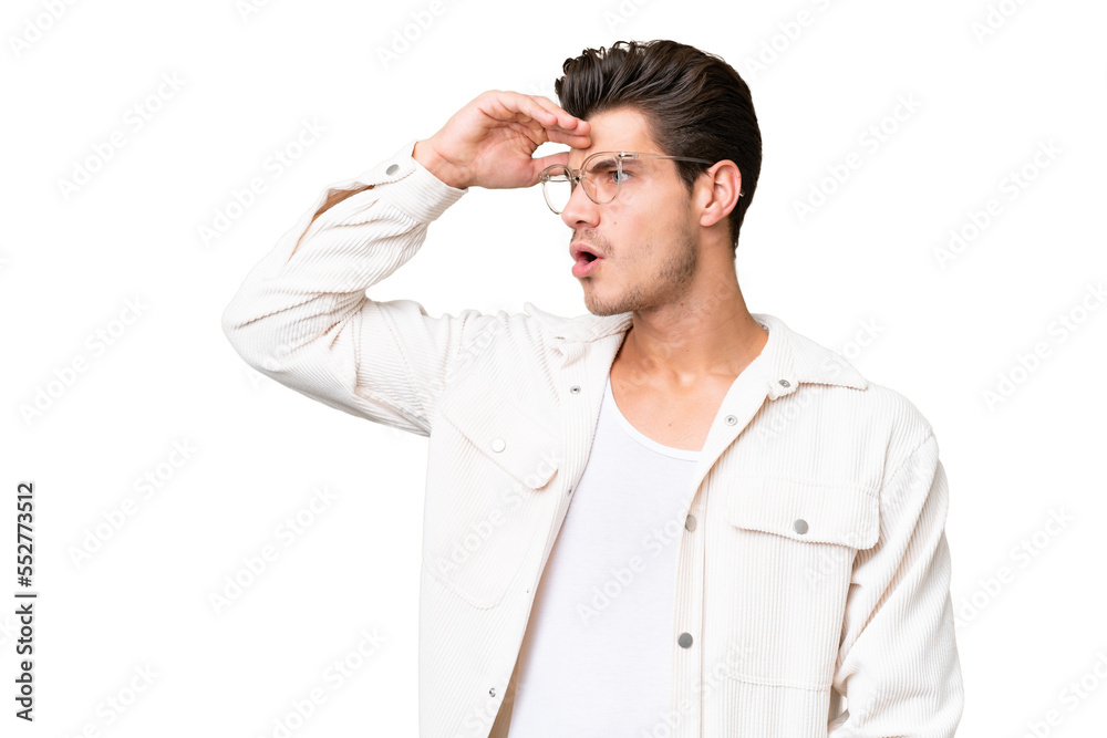 Young handsome caucasian man over isolated background with surprise expression while looking side Young handsome caucasian man over isolated background with surprise expression while looking side