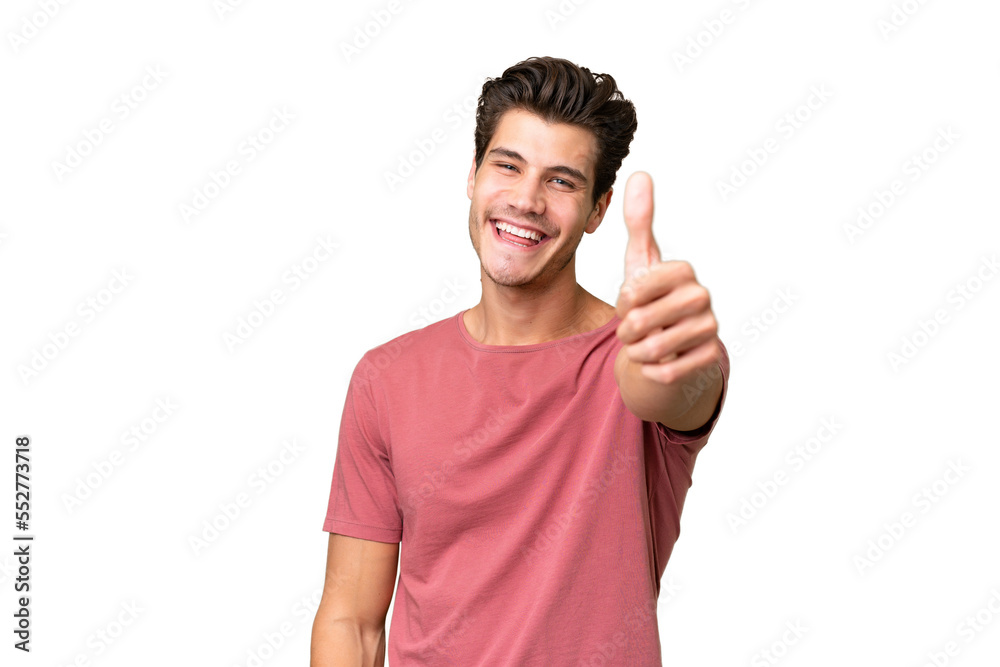 Young handsome caucasian man over isolated background with thumbs up because something good has happened