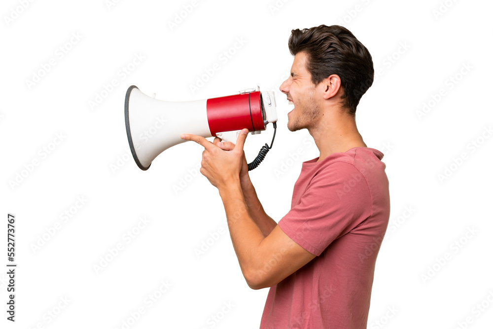 Young handsome caucasian man over isolated background shouting through a megaphone Young handsome caucasian man over isolated background shouting through a megaphone
