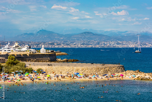 Panoramic view of harbor and Plage de la Gravette beach at historic old town onshore Azure Cost of Mediterranean Sea in Antibes resort town in France