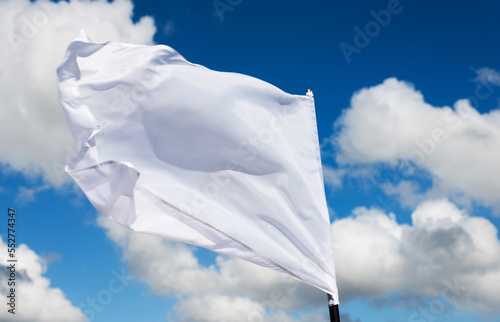 White flag flying against blue sky