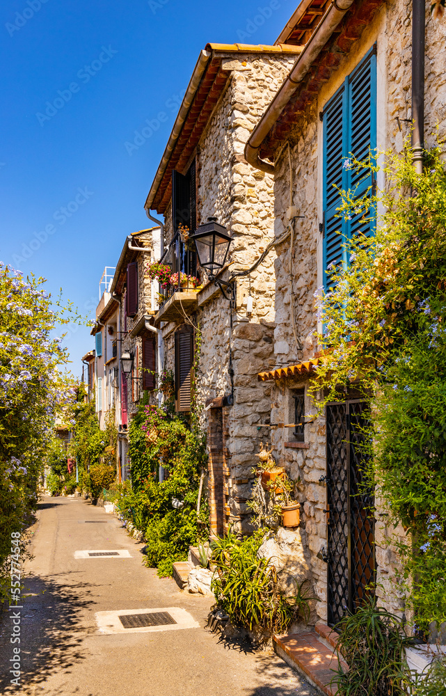 Rue des Revennes street with colorful vintage houses in historic old town of Antibes resort city onshore Azure Cost of Mediterranean Sea in France