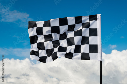 Checkered flag on blue sky