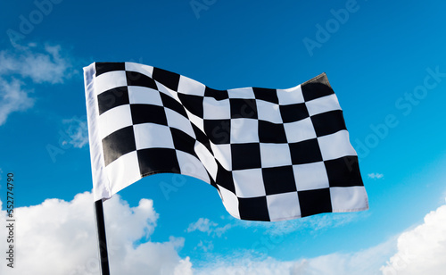 Checkered flag on blue sky