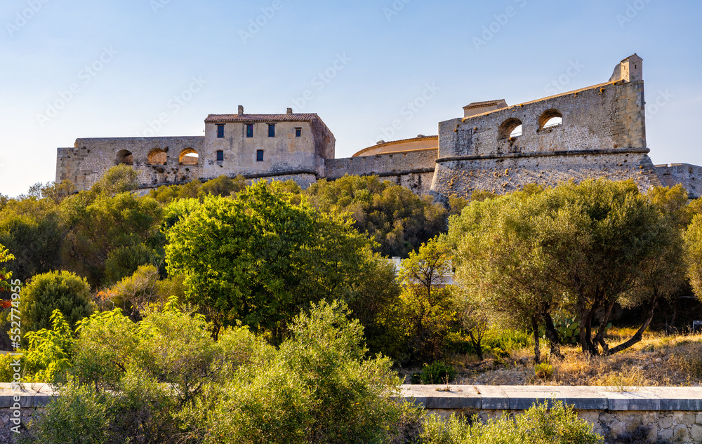 Fototapeta premium Defense walls and towers of medieval fortress Fort Carre castle in Antibes resort city onshore Azure Cost of Mediterranean Sea in France