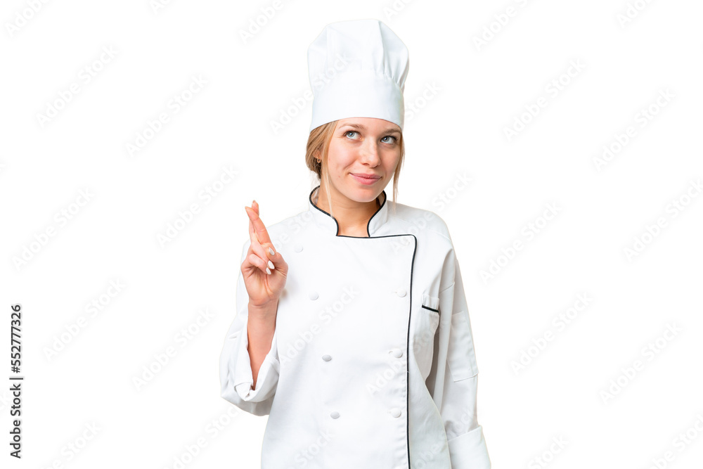 Young chef woman over isolated chroma key background with fingers crossing and wishing the best Young chef woman over isolated chroma key background with fingers crossing and wishing the best