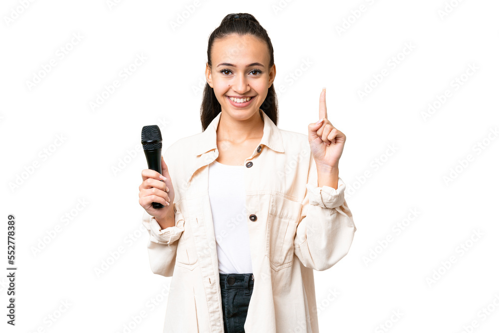 Young singer woman picking up a microphone over isolated chroma key background pointing up a great idea Young singer woman picking up a microphone over isolated chroma key background pointing up a great idea