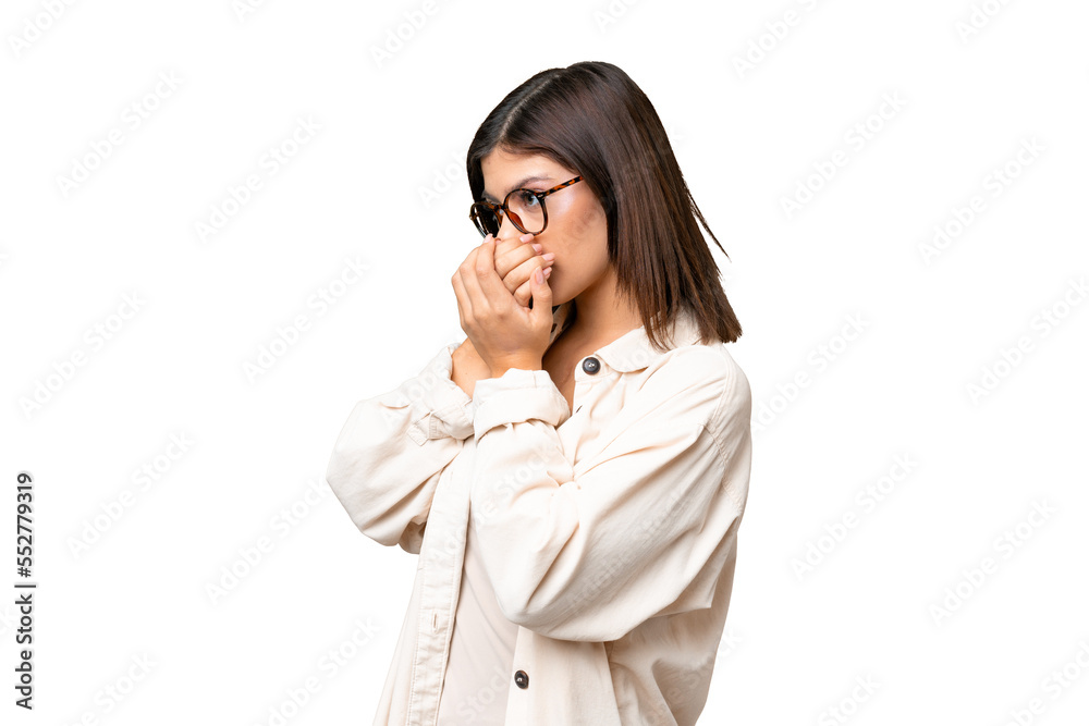 Young Russian woman over isolated chroma key background covering mouth and looking to the side Young Russian woman over isolated chroma key background covering mouth and looking to the side