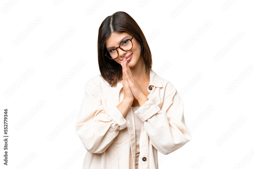Young Russian woman over isolated chroma key background keeps palm together. Person asks for something Young Russian woman over isolated chroma key background keeps palm together. Person asks for something